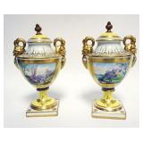 1003	PAIR OF MEISSEN URNS WITH GILT SERPENT HANDLES, BRONZE FINIAL ON LIDS, EACH APPROXIMATELY 10 IN