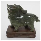 1037	CARVED QUARTZ ASIAN FOO DOG ON WOOD STAND APPROXIMATELY 5 IN X 2 1/2 IN X 5 IN H