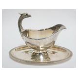 1084	CHRISTOFLE GRAVY BOAT WITH ATTACHED UNDER PLATE, APPROXIMATELY 9 IN X 5 1/2 IN X 7 IN H