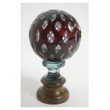 1105	RUBY GLASS CUT TO CLEAR SPHERE PAPERWEIGHT MOUNTED ON BRASS BASE