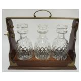 1122	LOCKING TANTALUS W/KEY HAVING 3 CRYSTAL DECANTORS, APPROXIMATELY 16 IN X 7 IN X 14 IN HIGH