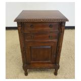1192	MAHOGANY 2 DRAWERS, ONE DOOR STAND W/CARVED HALF COLUMNS IN FRONT, APPROXIMATELY 21 IN X 16 IN 