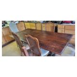 long wooden dining table with wrought iron legs
