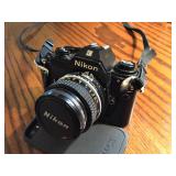 Nikon EM camera with 50mm lens and UV filer, strap and case