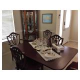 Rounded glass curio cabinet with four adjustable glass shelves.