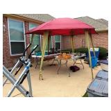 a pop up gazebo.  Approximately 12 x 12.  Steel legs.  Easy up and down.