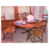 Pedestal dining table with five chairs, 2 leaves and 2 additional support legs.