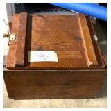 Vintage military ammunition box with rope handles and latches.