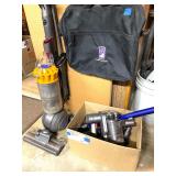 Dyson upright vacuum and Dyon Handheld vacuum with accessories.
