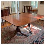 ANTIQUE DOUBLE PEDESTAL DINING TABLE | veneered top, ball and claw feet on casters, with extra leave
