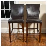 PAIR BAR STOOLS | Faux-leather upholstered high seats; some wear to seat material and wood frame; h.