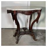 SERPENTINE MARBLE SIDE TABLE | Antique white marble top and four bowed legs which extend to a flat h