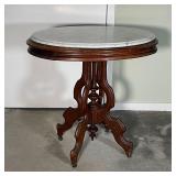 OVAL MARBLE SIDE TABLE | Oval mahogany table with white marble top, supported by a central column wi