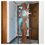 OAK HALL TREE | Having 7 arms with turned wood coat hooks surrounding a mirror, umbrella stand botto