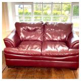 RED LEATHER LOVESEAT | Two seat red leather sofa; h. 36 x w. 69 x d. 37 in. 