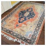 GEOMETRIC AREA RUG | Blue medallion on a salmon field within a border of flowers, with fringed ends;