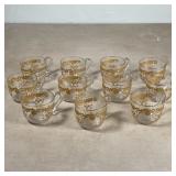SET GOLD ETCHED PUNCH CUPS | A set of 11 glass punch cups decorated with gold scrollwork; w. 4 in. 