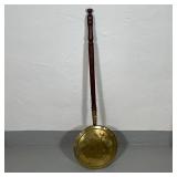 ANTIQUE BED WARMER | Incised brass on a turned wood handle; overall l. 39-1/2 in. 