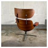 EAMES STYLE LEATHER CHAIR & OTTOMAN | By Selig Manufacturing, having saddle brown leather upholstery