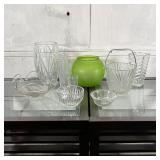 GROUP DECORATIVE GLASSWARE | A collection of glass vases and bowls, including a green glass fish bow