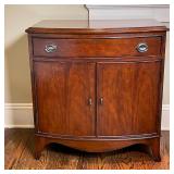 BOW FRONT BEDSIDE CABINET | End table or nightstand, with nickel hardware, having a single full-widt