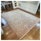PATTERNED WOOL CARPET | Handmade, having a beige field with an overall pattern of aubergine devices,