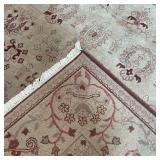 PATTERNED WOOL CARPET | Handmade, having a beige field with an overall pattern of aubergine devices,