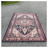 GEOMETRIC MEDALLION RUG | Pink medallion on a blue ground with a salmon border with rosettes and lea