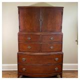 BOW FRONT TALL CHEST | Single piece construction designed in three sections, having double cabinet d