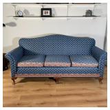 CAMELBACK SOFA | Three cushion sofa with unique floral upholstery having a pattern of red flowers 