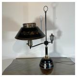 ANTIQUE TOLE FLUID LAMP | Back tole base and shade painted with gold leaf motif; h. 25-1/2 in.
