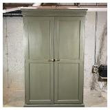 SCHRAGER GREEN CABINET | Double door storage cabinet in overall green paint with woven metal pulls, 