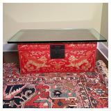 GILT RED PAINTED CHINESE BOX | Decorated with foo dogs and lions, scrolls, and with brass hardware a
