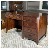 OFFICE DESK | Art deco style desk of nicely figured wood, with thin center drawer flanked by...