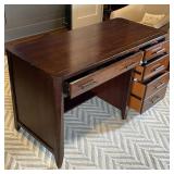 OFFICE DESK | Art deco style desk of nicely figured wood, with thin center drawer flanked by...