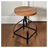 INDUSTRIAL LOW SWIVEL STOOL | Round wood block seat with natural finish atop a curved black frame