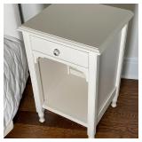 Nightstand with a single top drawer with a glass pull over an open lower shelf