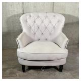WINGED CLUB CHAIR | Cream colored fabric club chair with tufted backrest and tacked side accents...