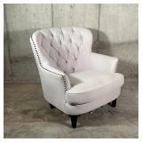 WINGED CLUB CHAIR | Cream colored fabric club chair with tufted backrest and tacked side accents...