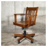 Desk chair with slatted backrest and open arms, with piston adjustments and recline; h. 34-1/4