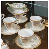 three painted items, to mounted bud vases (one detached), and a Bavarian china cylindrical box