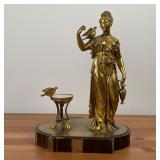 GILT METAL SCULPTURE | Robed figure with a bird upon her shoulder holding a ewer beside a bird bath 