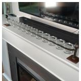 JAN BARBOGLIO VOTIVE HOLDER | Having a wrought iron frame suspending twelve glass votive candle hold