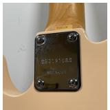 Korean-made, telecaster form, peach color with black pick guard, minor fritting to back end corner 