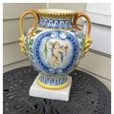 MAJOLICA URN | Showing a cherub holding a torch one one side and inscribed "S.F." on the other, with