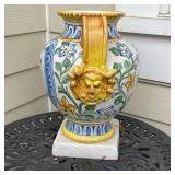 cherub holding a torch one one side and inscribed "S.F." on the other, with sculpted figural side ha