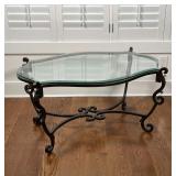 IRON & GLASS LOW TABLE | beveled glass top resting on a wrought iron scroll-decorated frame; 19 x 37