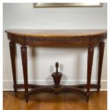 CARVED SIDE TABLE | Demilune top with carved frieze and x-stretcher with acorn finial; 31 x 44 x 14 