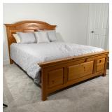 BROYHILL QUEEN BED | Light pine headboard and footboard connected with matching wood frame runners, 