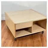 LIGHT WOOD LOW TABLE | Inset glass top, over a single drawer; on rolling casters; 16 x 31 x 31